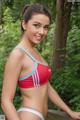 A woman in a red and blue bikini posing for a picture.